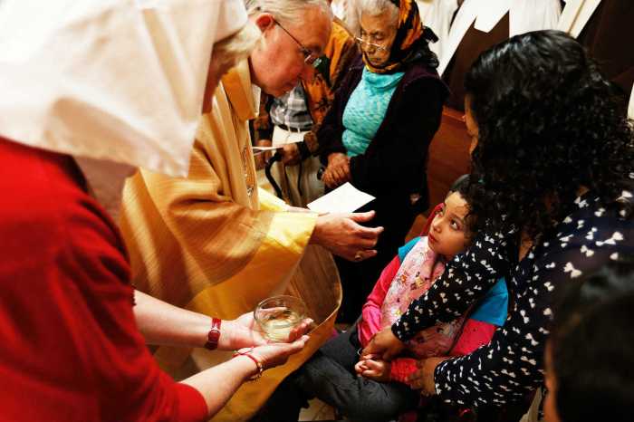 Rub with ointment as in a religious ceremony